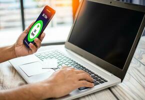 man holds smartphone to watch heart function monitor. Mobile device screen monitors health. Concept of using technology to take care of human health by using digital devices, Internet. Selective focus photo