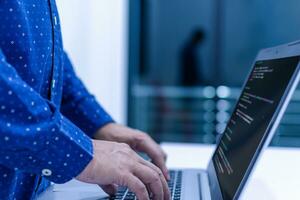 programmer coding, compiler, encode, debug, and developer application software for business corporate with laptop computer. Man programming coding web app from work at home, code show screen monitor photo