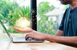 businessman uses a smartphone and laptop with a cloud computing diagram display on a virtual screen. Cloud technology. Data storage. Networking server and backup database on the internet service photo