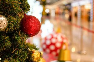 Close up Christmas tree decorated with small bulbs is beautiful. Christmas tree decoration with white, red, golden balls, copy space on right for design or text, blurred background, beautiful bokeh. photo