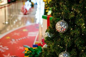 Closeup small white balls on a Christmas tree decorated 2020 with small bulbs are beautiful. Copy space and beautiful bokeh on left for design or text, blurred background. photo
