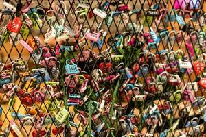 love locks on the wall of the love lock museum in krakow, poland photo
