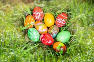 closeup, many beautiful painted easter eggs as grass blurred background. concept for good friday, easter monday, spring full moon. copy space on top for text or design. garden, nobody, selective focus photo