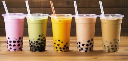 Plastic cups of different tasty bubble tea on wooden background. Generative AI photo