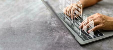 Process data and manage files on Internet efficiently. Online document database system and electronic document management system concept. Businessman working from home using laptop with virtual screen photo