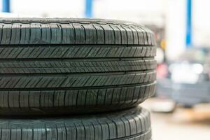 Tires for wheels are sold in car service centers. Closeup, copy space, Blurred background. photo