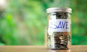 Coins in many pots and save messages for savings, investments, and emergency money, economy concept. nobody, No People, No People copy space and blurred background photo