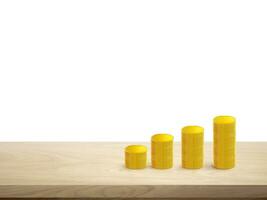 Stacks of gold coins in a row on a wooden table Isolated on a white background photo