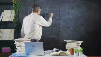 Historian man writing History of India on blackboard. video