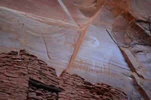 Faint Rudimentary Drawings Above Cliff Dwellings on Rock Face photo