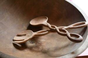 Hand Carved Wooden Salad Tongs in a Bowl photo