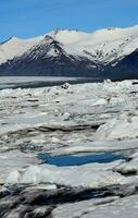 Summer Thaw with Glaciers and Snow Capped Peaks photo