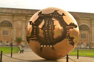 Symbolic statue in vatican city of a large sphere photo