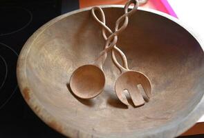 Twisting Carved Salad Spoon and Fork in a Wood Bowl photo