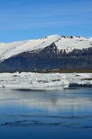 Glacier Melting into the Lagoon in Iceland photo