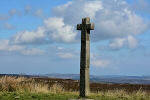 Stone Memorial Cross Overlooking the Moors in North Yorkshire photo