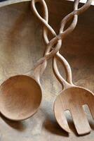Beautifully Carved Wooden Salad Tongs in a Bowl photo