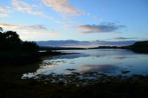 Beutiful Silhoeutted Loch Dunvegan in Scotland photo