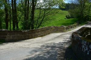 A Stone Bridge Winding Through Fields in Northern England photo