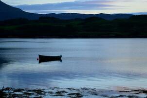 Silhouetted Dingy on Loch Dunvegan photo