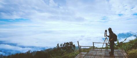 man asians travel relax in the holiday. Photograph landscape on the Moutain.Thailand photo