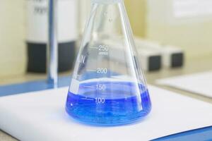 Flask with blue liquid in lab photo