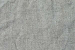 Texture of gray crumpled linen fabric close-up. photo