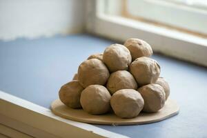 Pieces of clay balls on a plate. photo