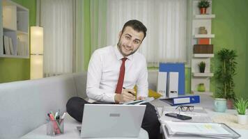 Young businessman waving at the camera. video