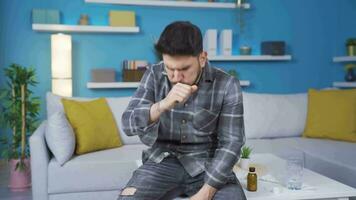 Young man with flu takes medicine at home. video