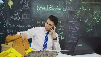 Businessman writes Small business on the blackboard and counts money. video