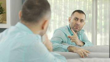 Man with mental and psychological problems is fighting in front of the mirror. video