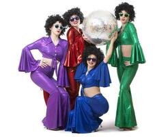 Girls in glasses and colorful disco costumes pose with a disco ball. Disco party. Halloween costume. photo
