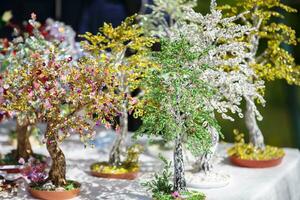 Handcrafted beaded trees for sale at the handicraft fair. photo