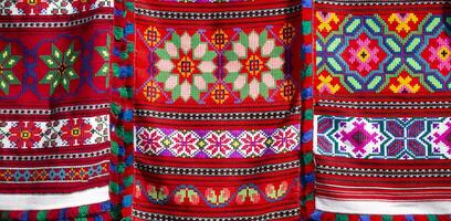 Beautiful towels, embroidered with Slavic patterns. Embroidery and manufacture of fabrics in the old days. Traditions. Ukrainian or Belarusian embroidered shirt. photo