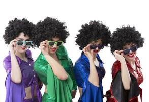 Disco style girls in colorful flared suits and African American wigs on a white background. Seventies or eighties style. photo