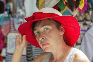 Middle-aged woman in a wide-brimmed beach hat photo