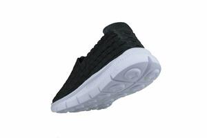 Black sneakers on white soles. Sport shoes on a white background. photo