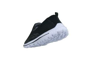 Black sneakers on white soles. Sport shoes on a white background. photo