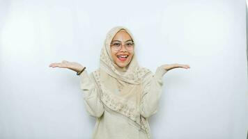 happy young asian woman in casual shirt. Charming female lady open hands palm up holding something on isolated White background. photo