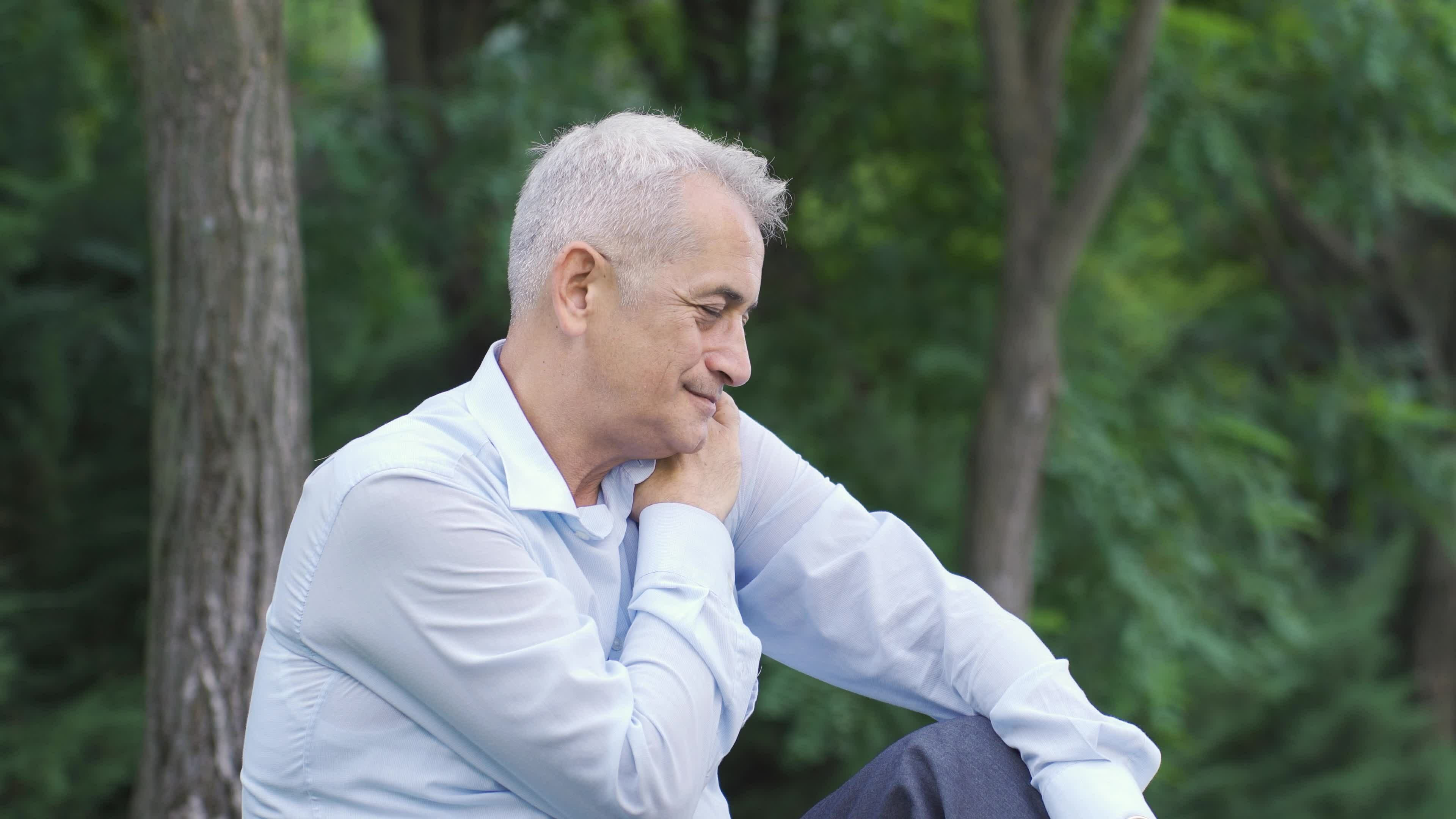 Emotional man sitting outdoors. 32424000 Stock Video at Vecteezy