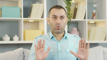 Man calming down by doing breathing exercise. video