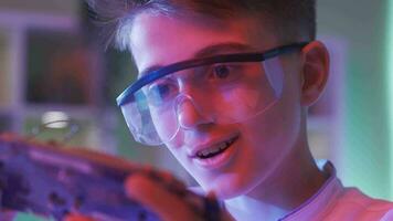 Close-up face of boy admiring electronic clipboard. video