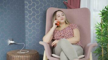 The young woman unplugs the charger from the outlet. video