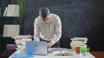 Historian man working on laptop taking notes, doing analysis. video