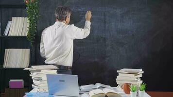 The historian man writing the History of England on the blackboard. video