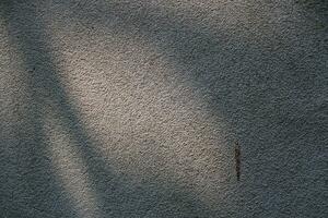 Sun shining on a cement wall background, grungy shiny wall surface, rusty cement wall backdrop photo