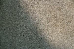 Cement and brick wall texture background, sun rays on the cement wall surface, smooth cement wall backdrop photo