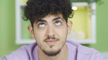 Close-up face shot of young man with curly hair, cute and positive posture. video