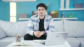 Young man talking while looking at camera is cheerful and happy. video